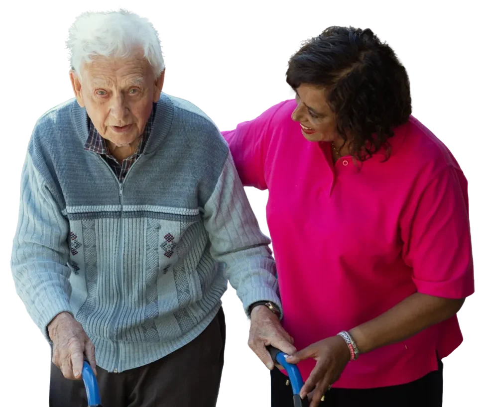 Caregiver assisting an elderly man with a walker, both smiling warmly.